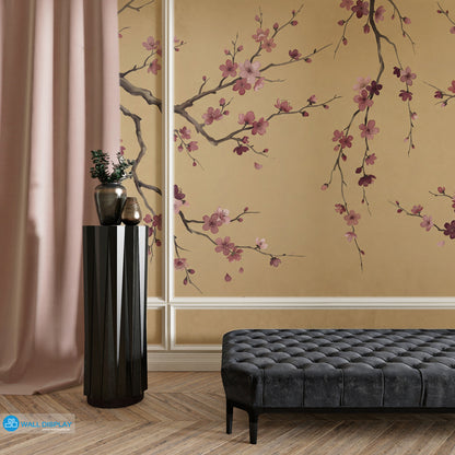 Golden Sakura Chinoiserie wallpaper mural with pink blossom branches on warm golden beige background for luxury interiors in Dubai UAE