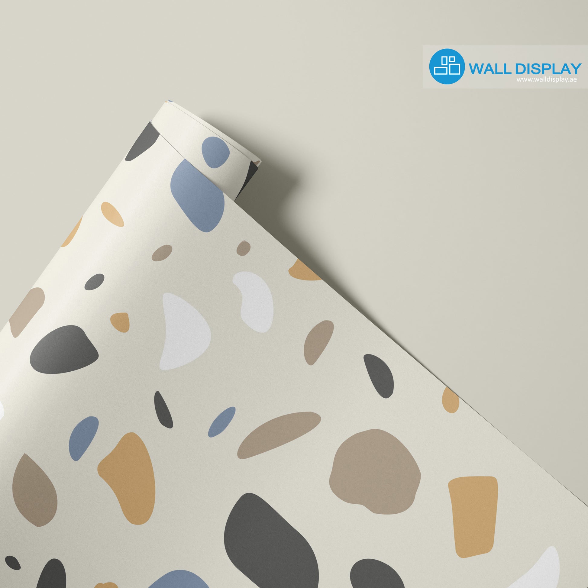 Modern terrazzo pattern wallpaper with beige, blue, tan, charcoal, and white abstract shapes on a neutral background for bathrooms, offices, and feature walls.