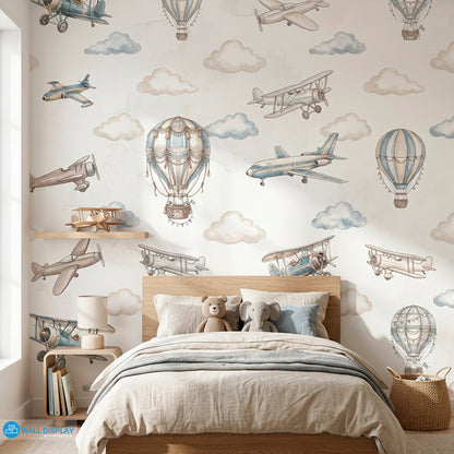 Vintage aviation kids wallpaper with watercolor airplanes, hot air balloons, and soft clouds in beige and dusty blue colors.