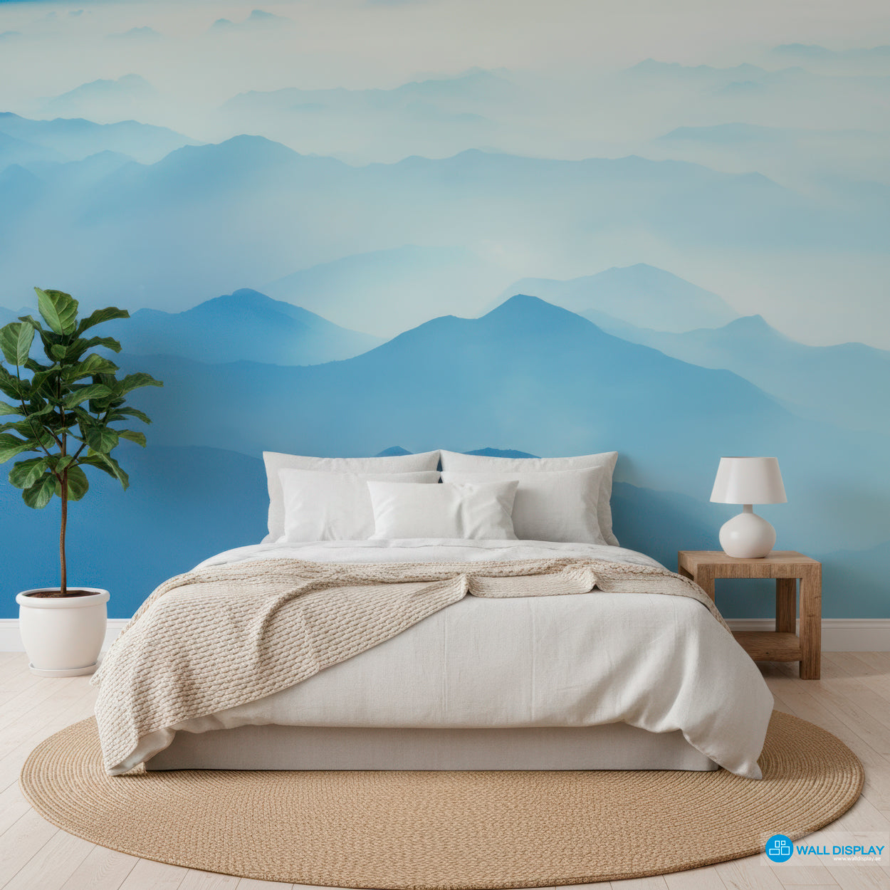 Bedroom with mountain mural on the wall, featuring a bed, lamp, and plant.