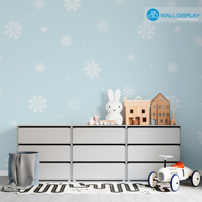 Snowflakes kids wallpaper with white snowflake patterns on a pastel blue background for nursery, baby room, and playroom walls.