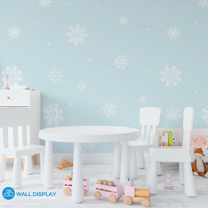 Snowflakes kids wallpaper with white snowflake patterns on a pastel blue background for nursery, baby room, and playroom walls.