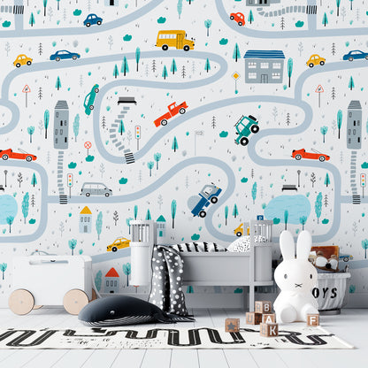 Vroom Zoom kids wallpaper with illustrated roads, cars, buses, trucks, houses, trees, and traffic signs for nursery, playroom, and children’s room walls.